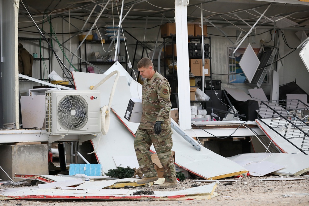 Soldiers, Airmen and contractors clearing debris after Al-Asad Airbase missile attack