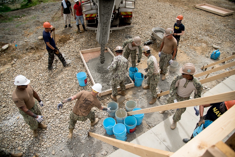 U.S. Navy Seabees deployed with NMCB-5’s Detail Palawan place concrete at Malatgao Elementary School