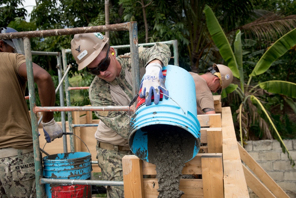 U.S. Navy Seabees deployed with NMCB-5’s Detail Palawan place concrete at Malatgao Elementary School