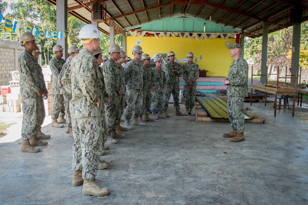 U.S. Navy Seabees deployed with NMCB-5’s Detail Palawan place concrete at Malatgao Elementary School