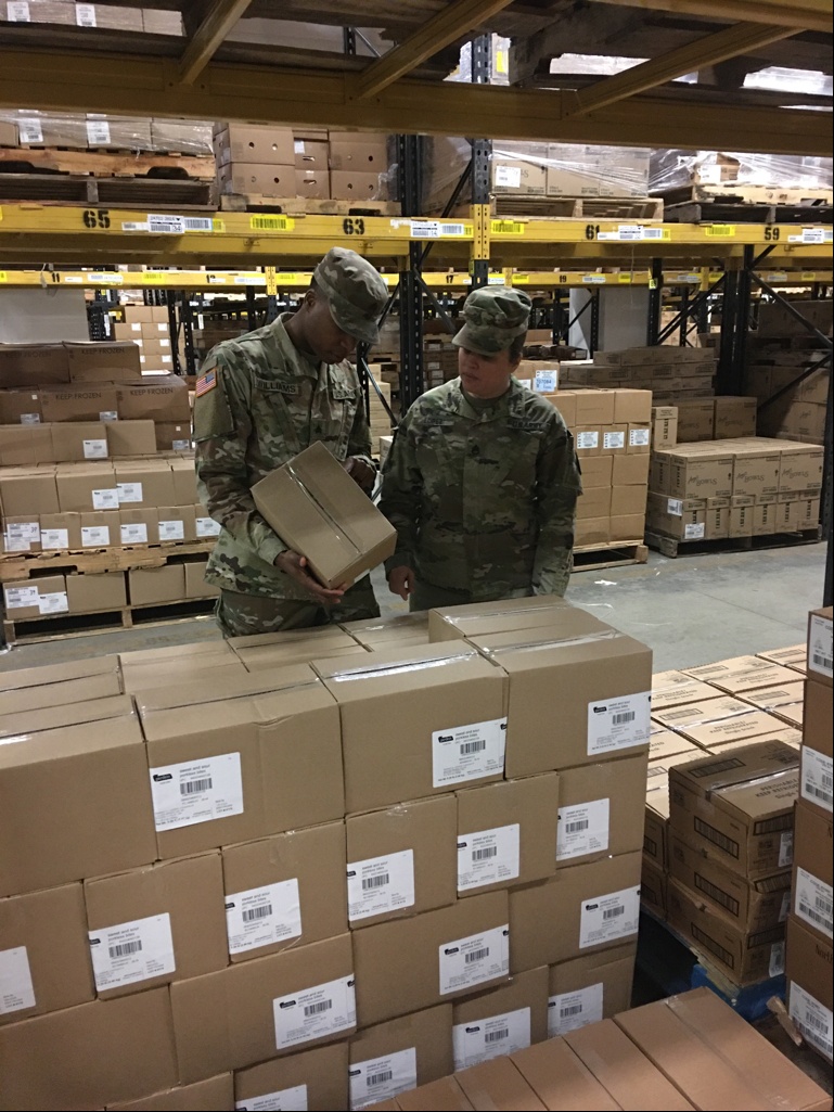 Sgt. Dominique Williams and Staff Sgt. Abigail Lopez, food inspectors at Veterinary Branch Kaiserslautern, inspecting freight for damages.