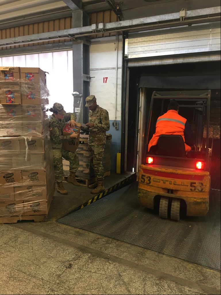 Staff Sgt. Abigail Lopez and Sgt. Dominique Williams, Food Inspectors at Veterinary Branch Kaiserslautern, unloading freight from a truck.