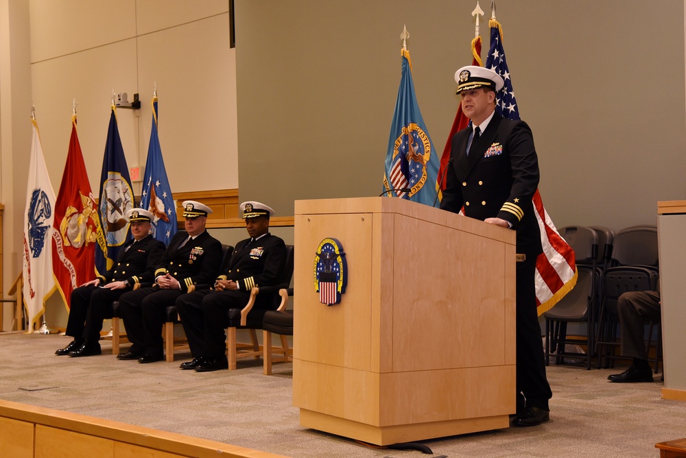 Cmdr. A.J. Kruppa speaks during a change-of-charge ceremony aboard NSA Philadelphia.