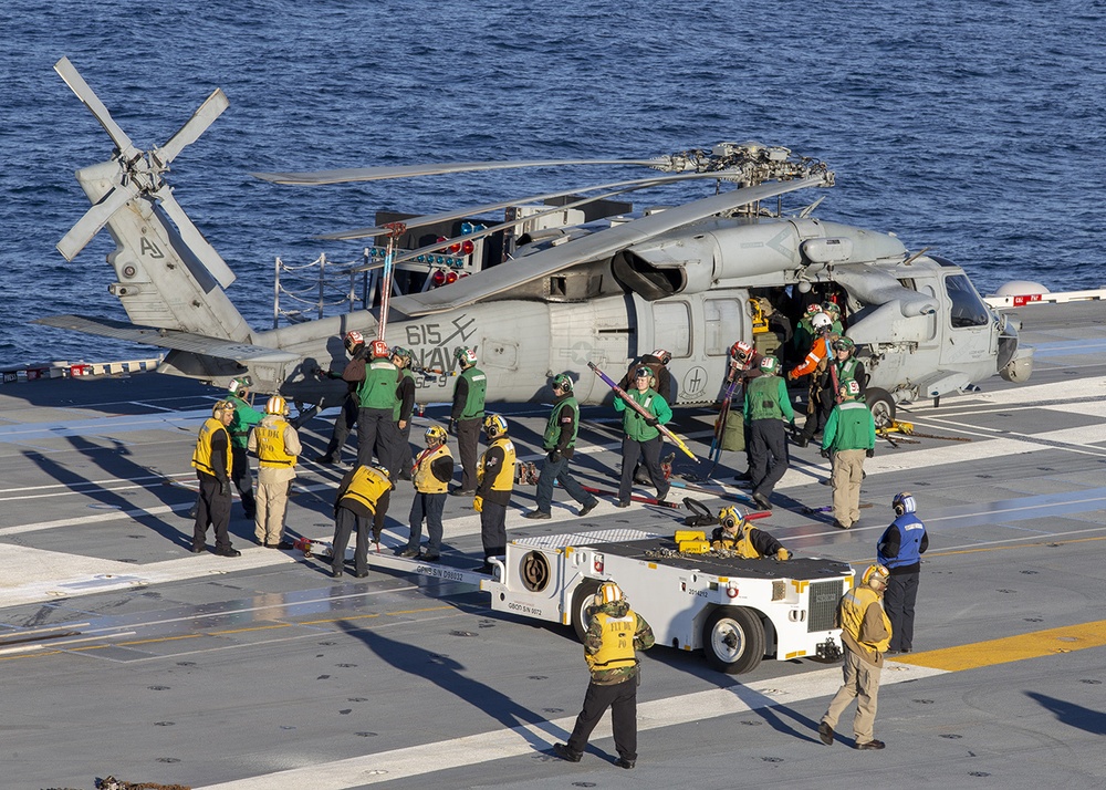 Sailors offload helicopter