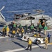 Sailors offload helicopter