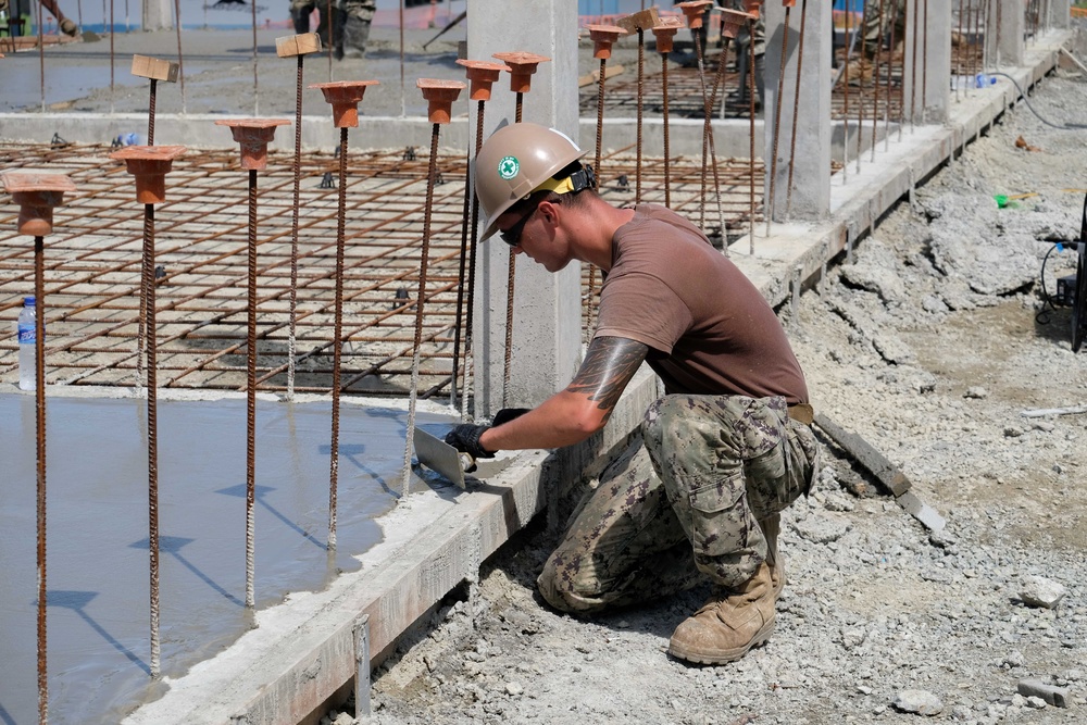 U.S. Navy Seabees deployed with NMCB-5’s Detail Timor-Leste build a three-room schoolhouse in Liquica, Timor-Leste