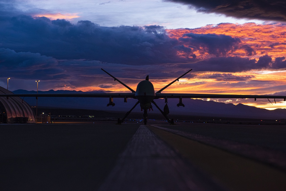 MQ-9 Reaper and aircrew underneath Nevada sunset