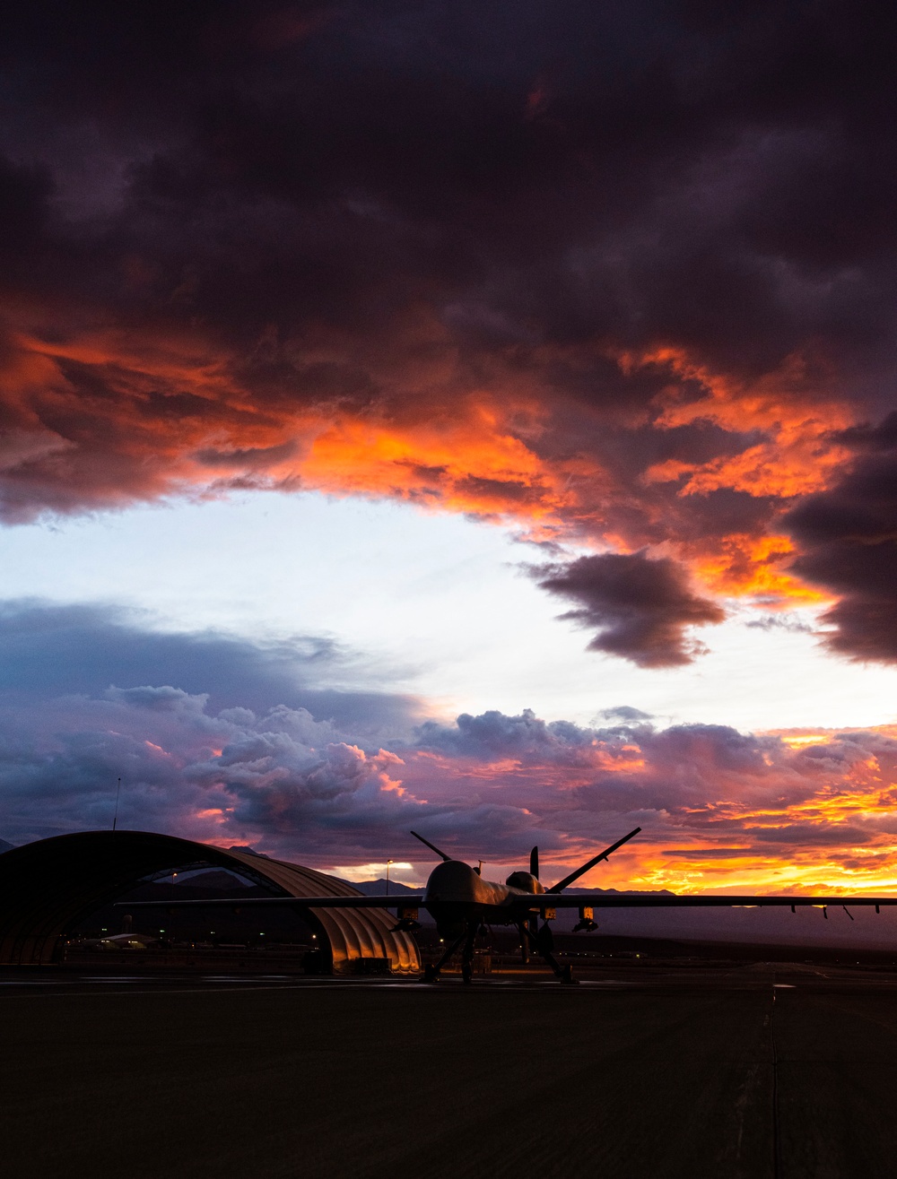 MQ-9 Reaper and aircrew underneath Nevada sunset