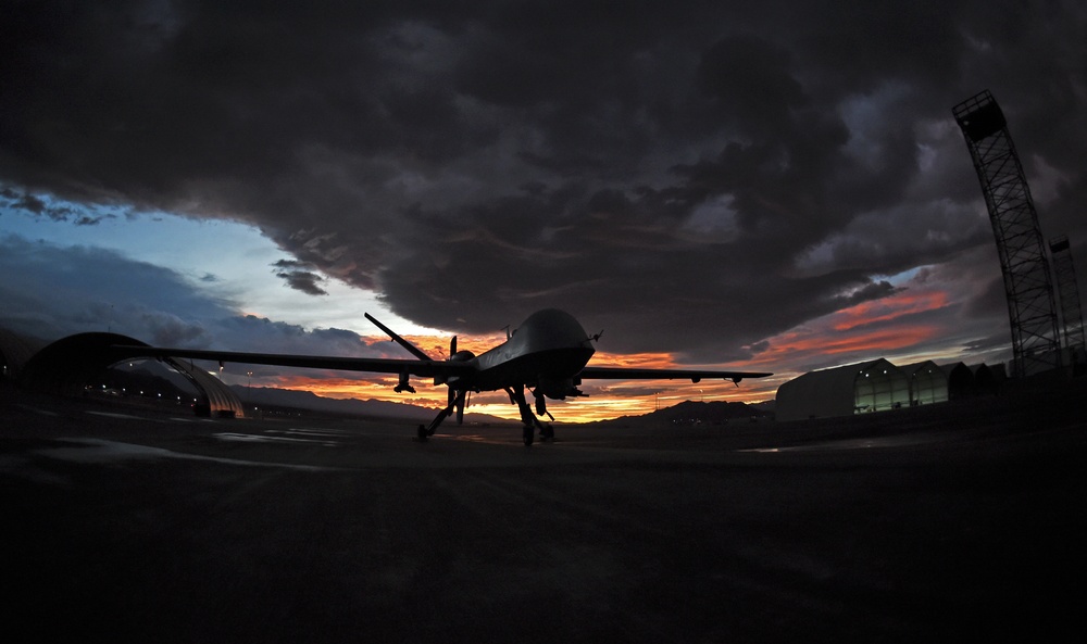 MQ-9 Reaper and aircrew underneath Nevada sunset