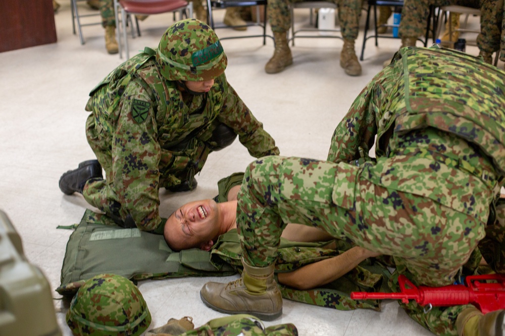 Iron Fist 2020: Japanese Ground Self Defense Force soldiers demonstrate combat medical care procedures to U.S. Sailors.