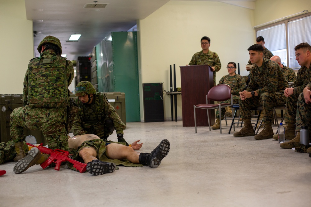 Iron Fist 2020: Japanese Ground Self Defense Force soldiers demonstrate combat medical care procedures to U.S. Sailors.