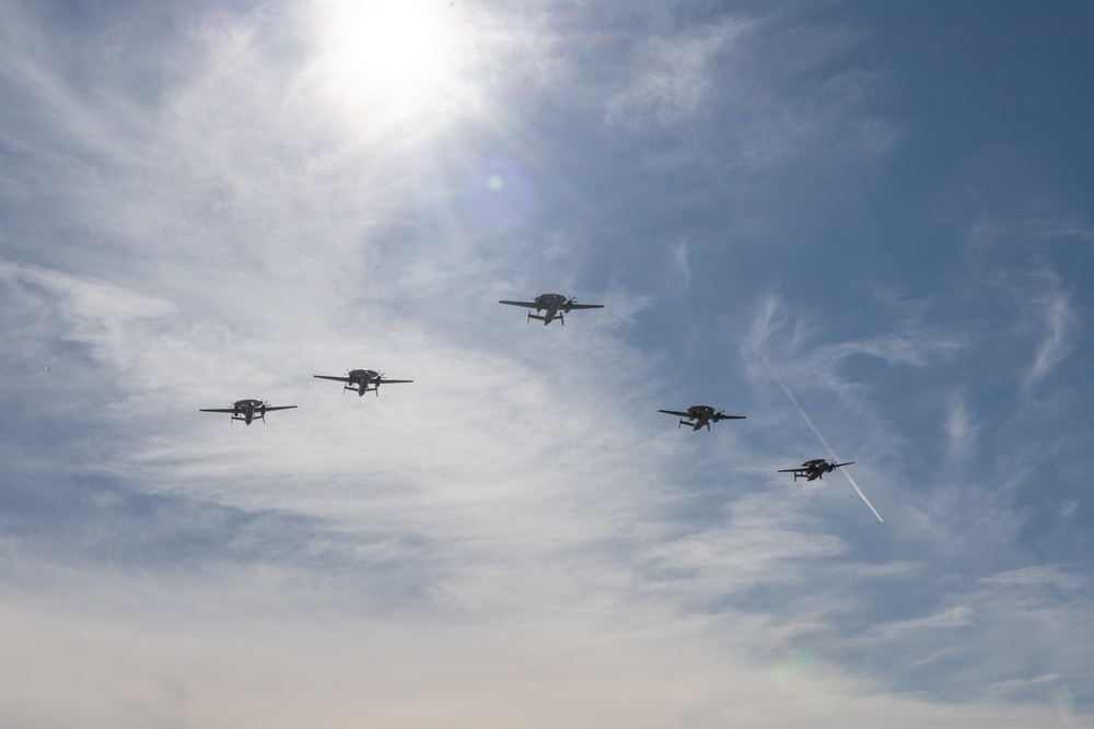 E-2D Hawkeyes fly in formation over an airfield in Norfolk
