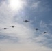 E-2D Hawkeyes fly in formation over an airfield in Norfolk
