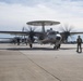 E-2D Hawkeyes fly in formation over an airfield in Norfolk