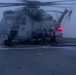 Sailors refuel a CH-53E on the flight deck of the New York