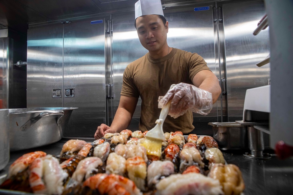 Sailors cook in the galley