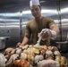 Sailors cook in the galley