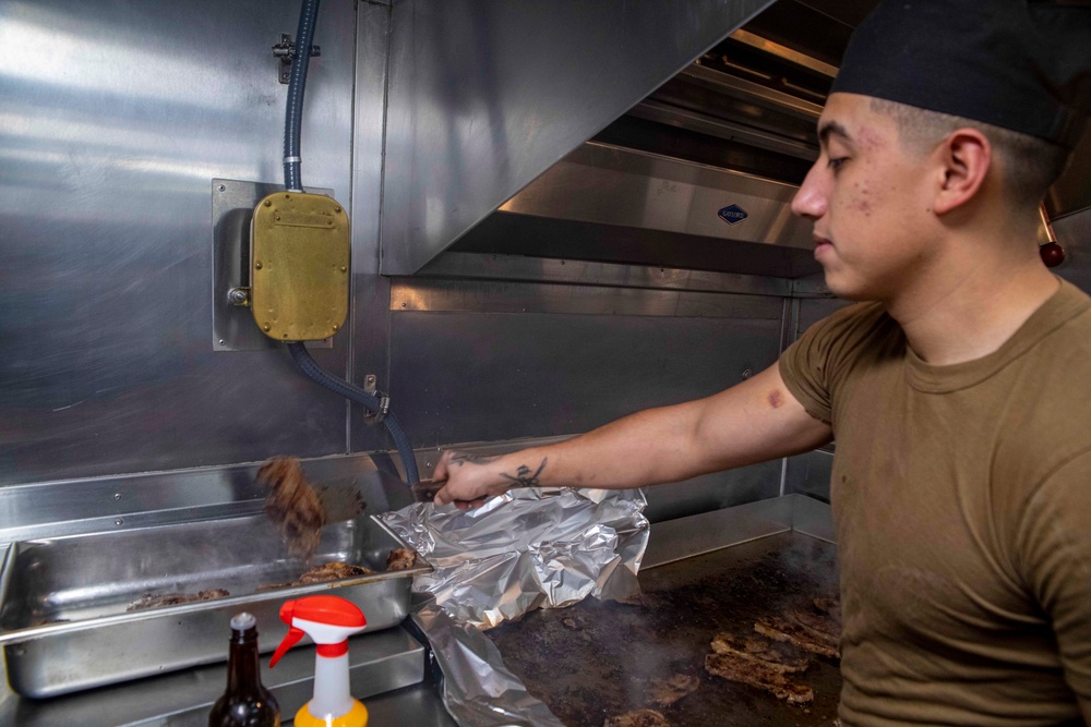 Sailors cook in the galley