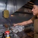 Sailors cook in the galley