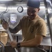 Sailors cook in the galley