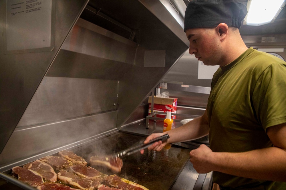 Sailors cook in the galley