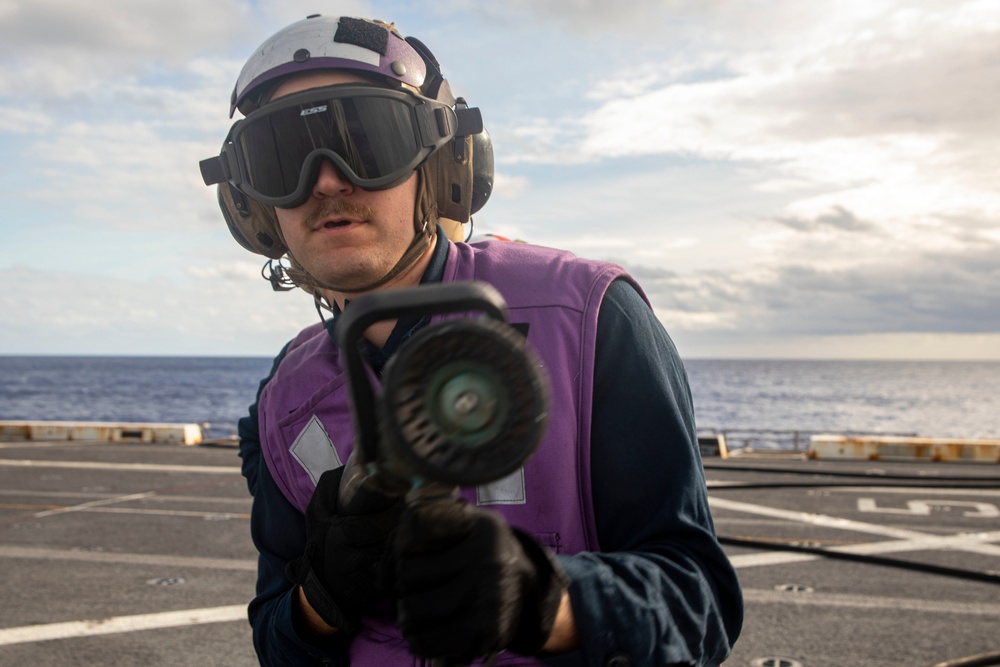 Sailors take part in flight deck fire fighting