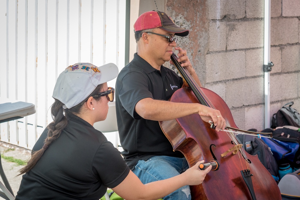 Volunteer Cellists Play for Quake Survivors