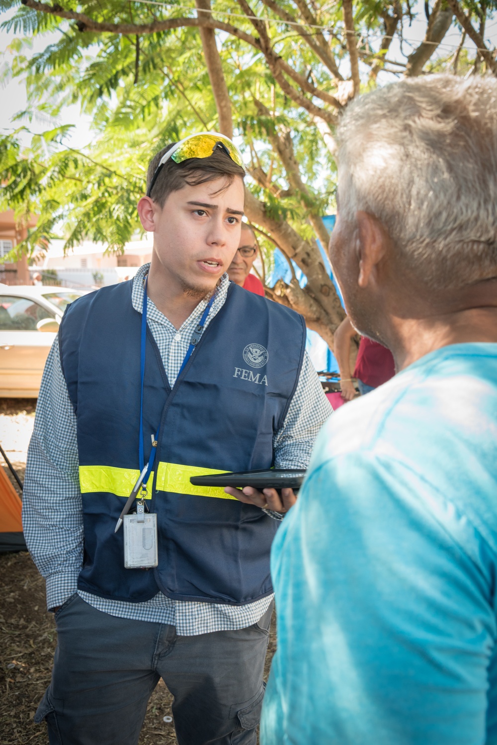 Disaster Assistance Team Member Talks with Quake Survivor