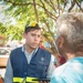 Disaster Assistance Team Member Talks with Quake Survivor