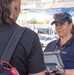 Disaster Assistance Team Member Talks with Quake Survivor