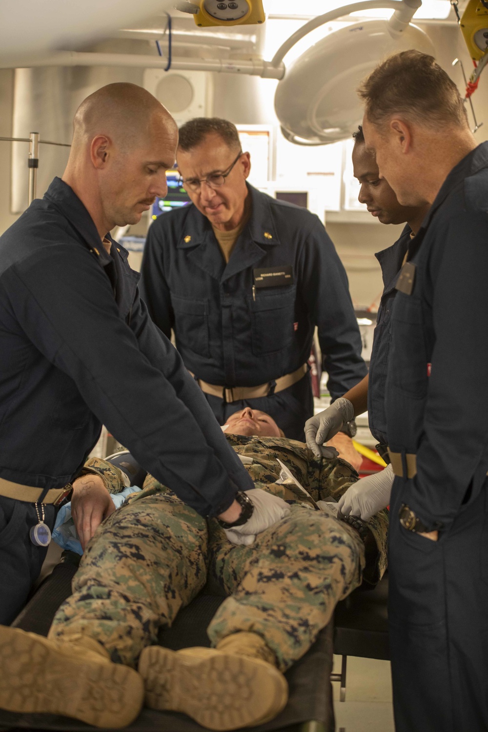 Sailors treat a simulated casualty