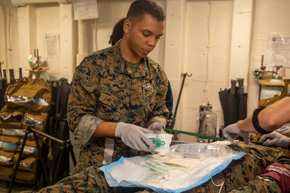 Corpsman sets up simulated IV