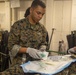 Corpsman sets up simulated IV