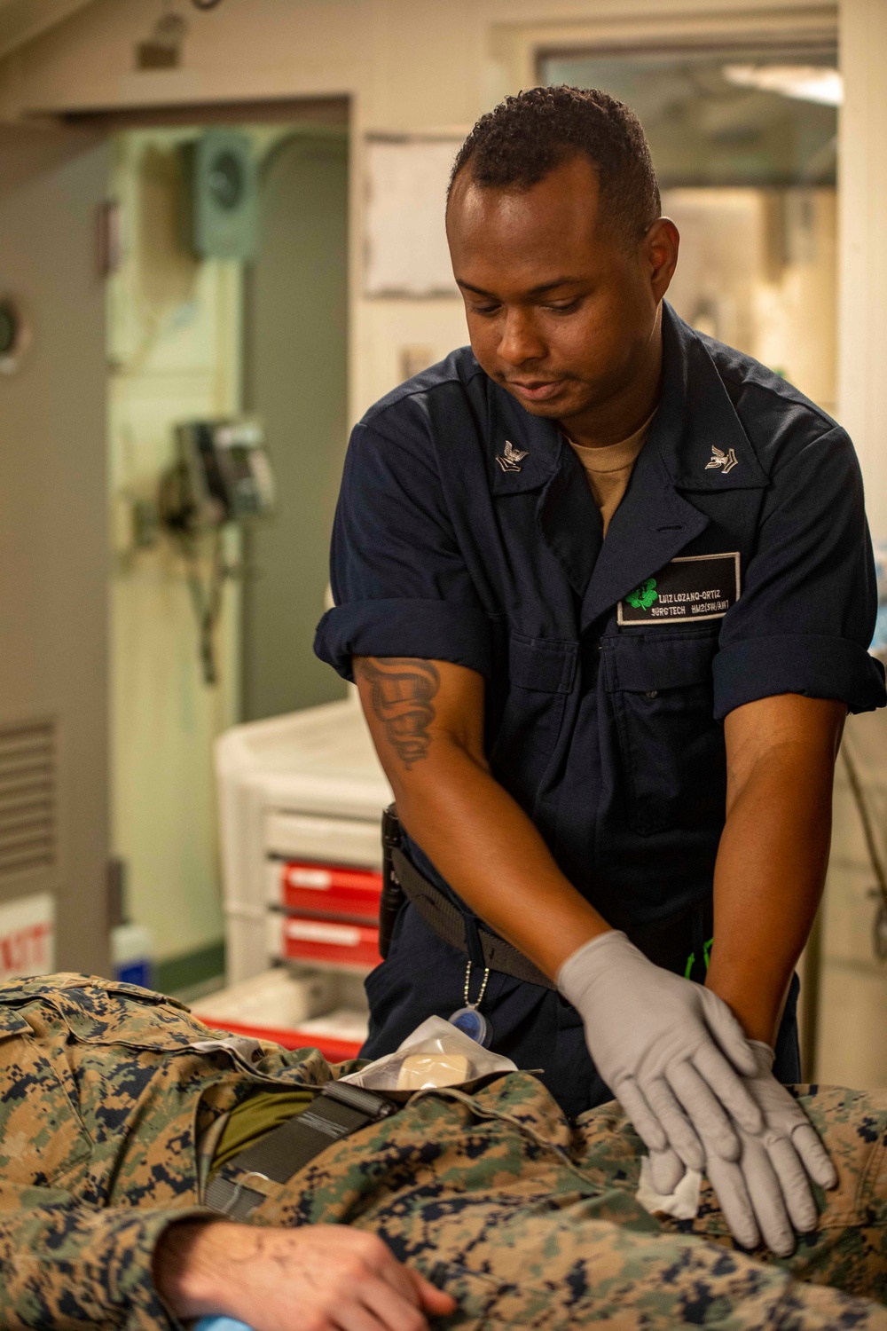 Corpsman keeps pressure on simulated wound