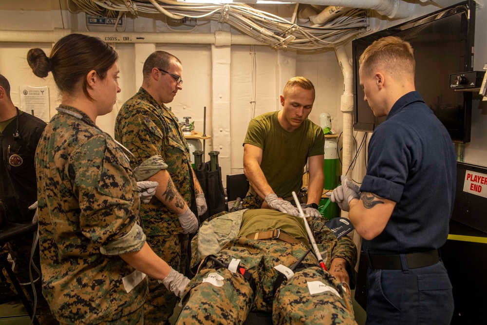 Sailors and Marines treat a simulated casualty