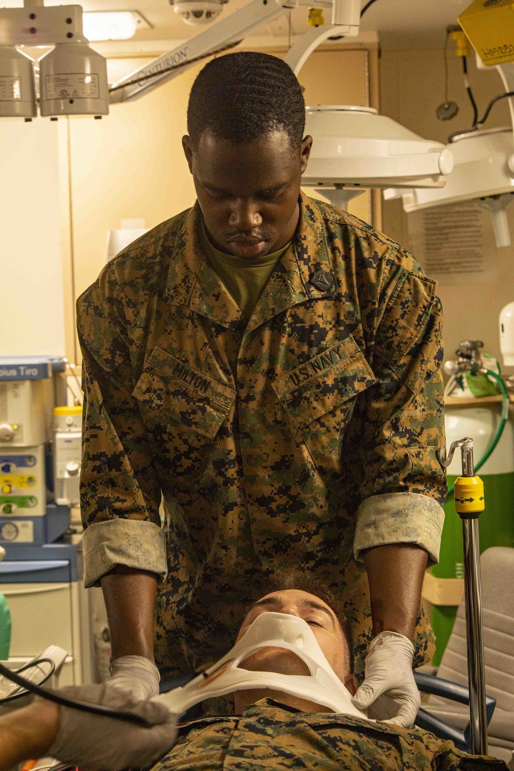 Medic places neck brace on simulated casualty