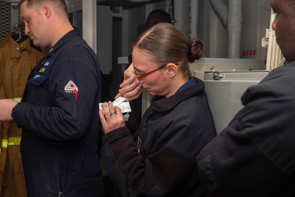 Sailor looks at a chemical agent detector kit