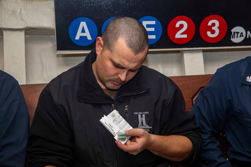 Sailor looks at a chemical agent detector kit