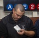 Sailor looks at a chemical agent detector kit