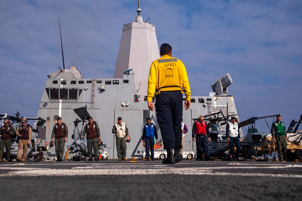 Sailors and Marines perform FOD walkdown.