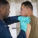 Corpsman give Sailor vaccine