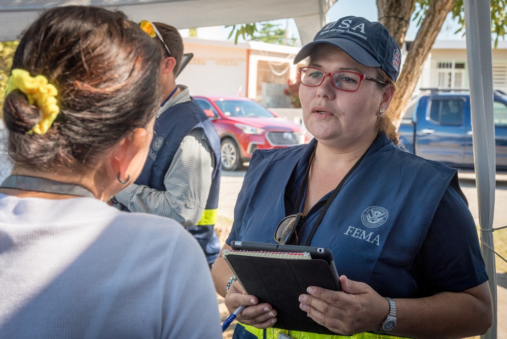 Disaster Assistance Team Member Talks with Quake Survivor