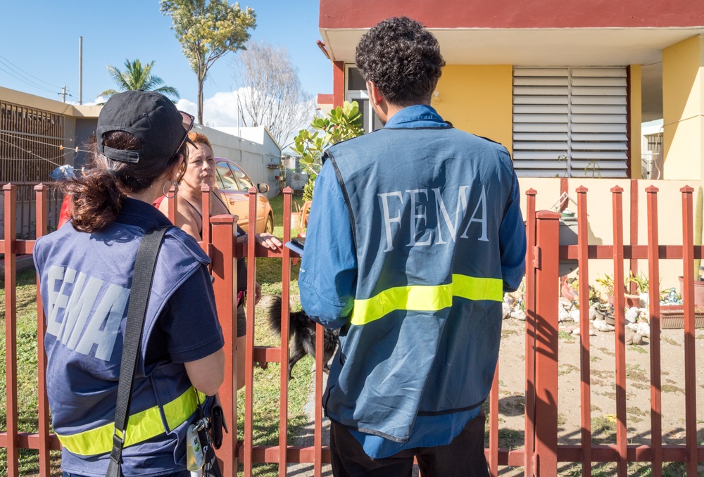 Disaster Assistance Team Members Talk with Quake Survivor