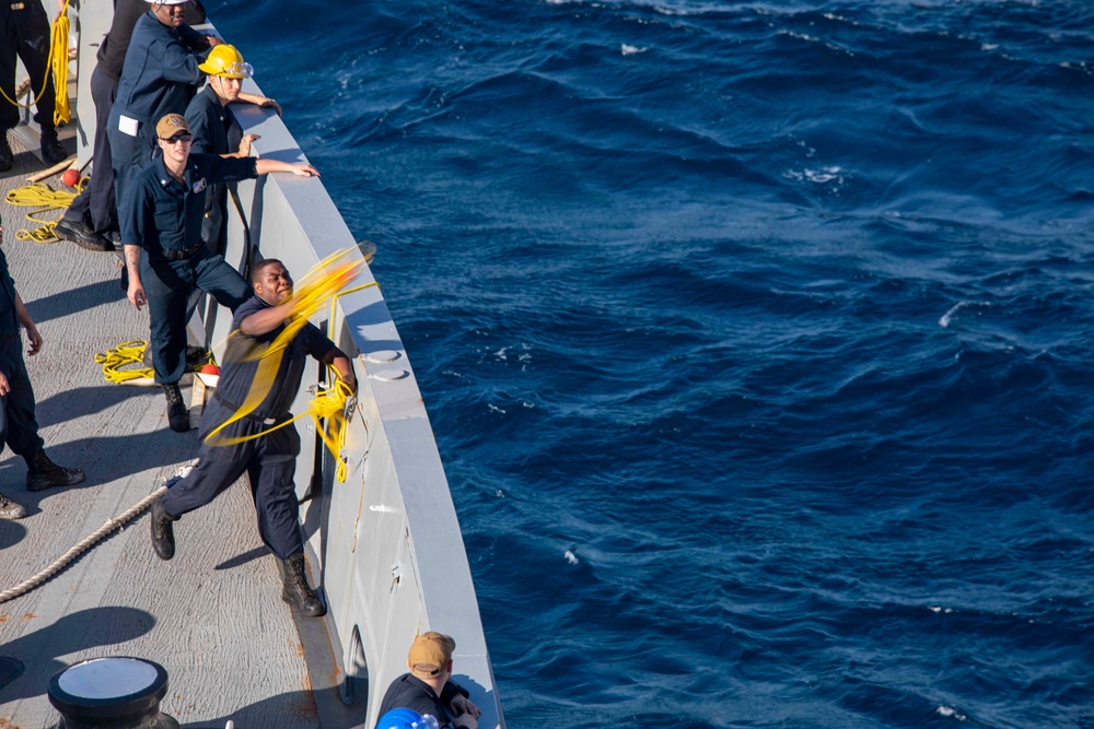 Sailor throws mooring line