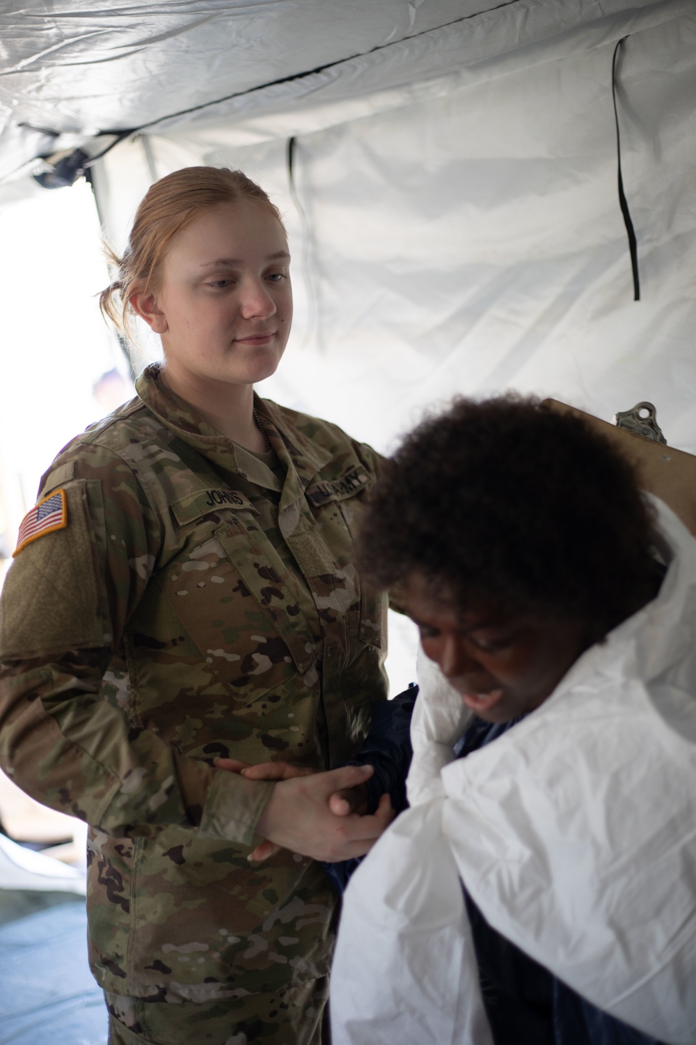 546th Area Support Medical Company Soldier Assists Role Player in Exercise Sudden Response 20