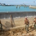 U.S. Navy Seabees repair a seawall on board Naval Base White Beach