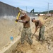 U.S. Navy Seabees repair a seawall on board Naval Base White Beach