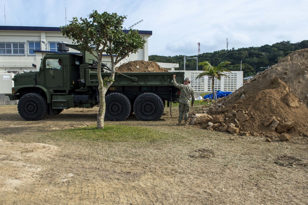 U.S. Navy Seabees repair a seawall on board Naval Base White Beach