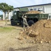 U.S. Navy Seabees repair a seawall on board Naval Base White Beach