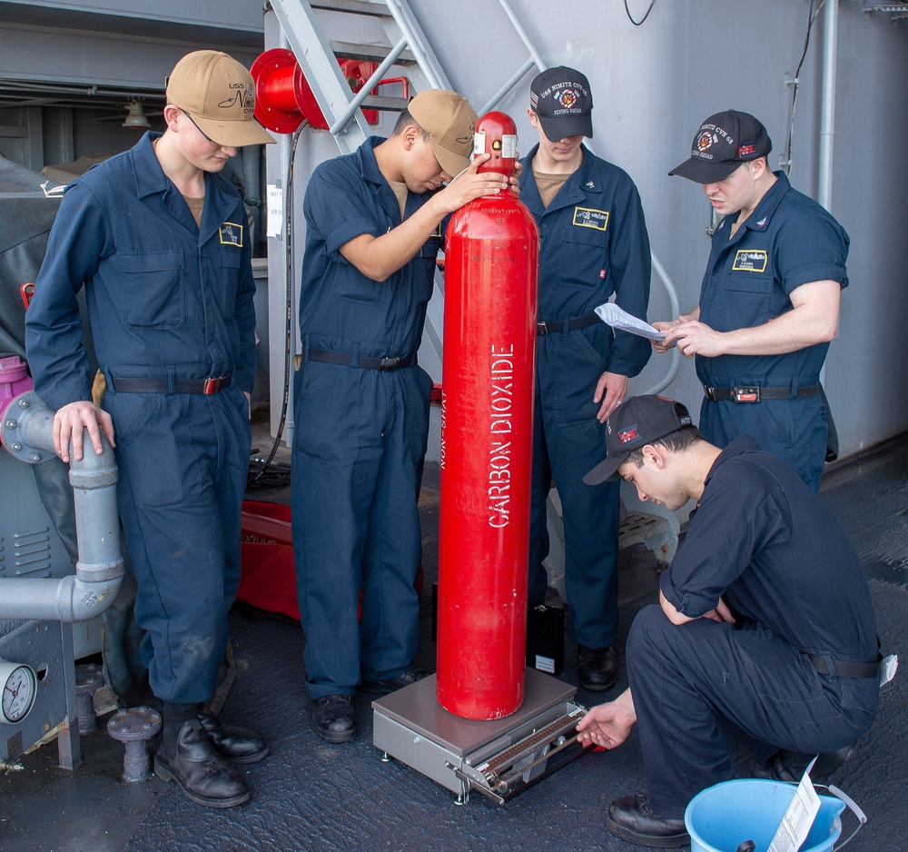 Sailors work aboard USS Nimitz (CVN 68)